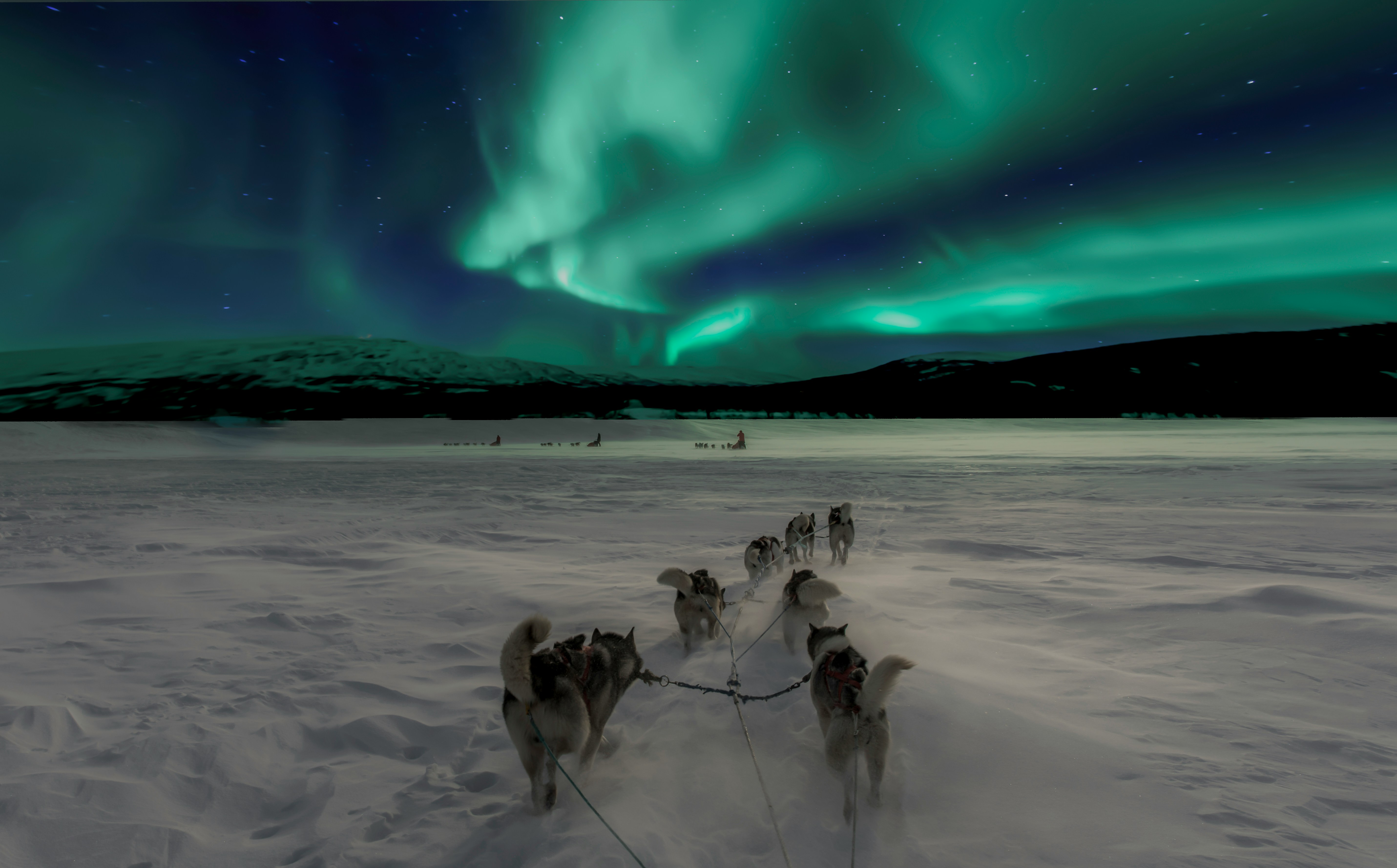 Aurora over snowy mountains in Norway
